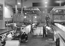405235 Afbeelding van personeel van de N.B.M. tijdens onderhoudswerkzaamheden aan autobussen in de busremise aan de ...